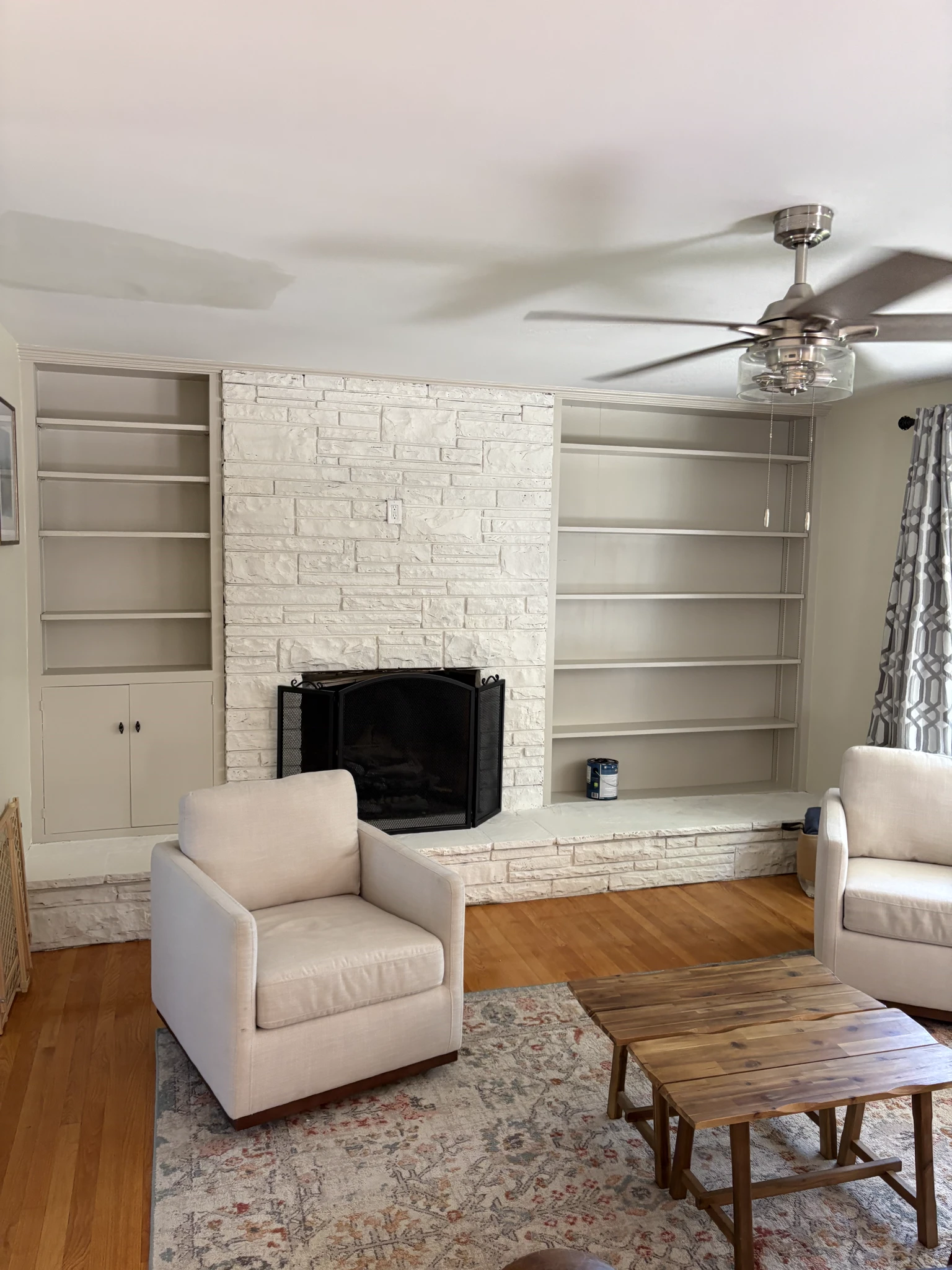 Painted stone fireplace and built-in bookshelves