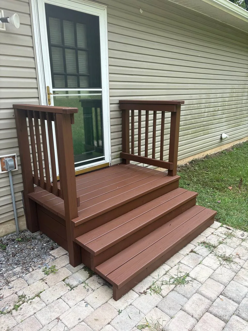 Back deck landing, steps and railing stained a deep brown