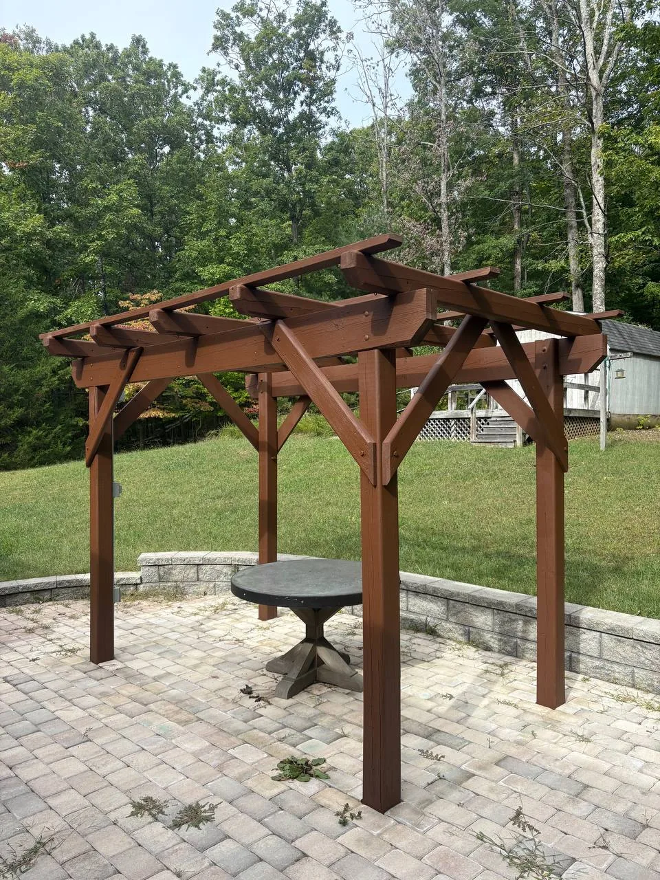 Pergola over a paver patio, stained a warm reddish brown